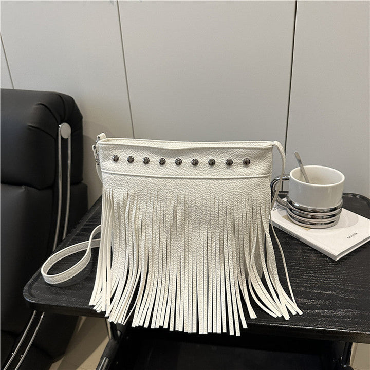 Ladies shoulder bag with fringes and studs