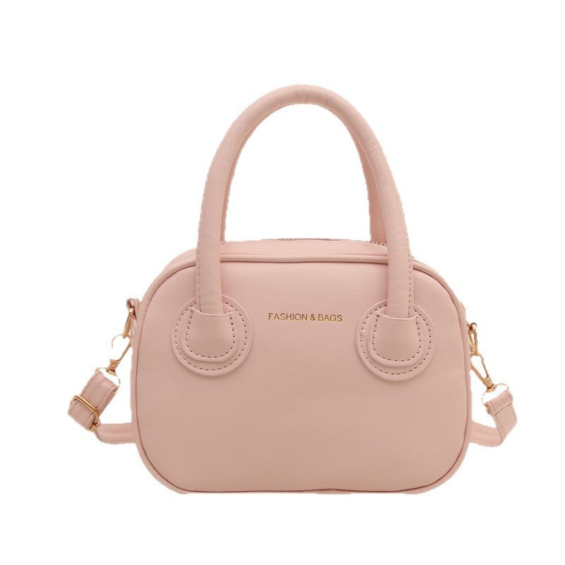 Ladies fashionable handbag with elegant pull handles and removable shoulder strap