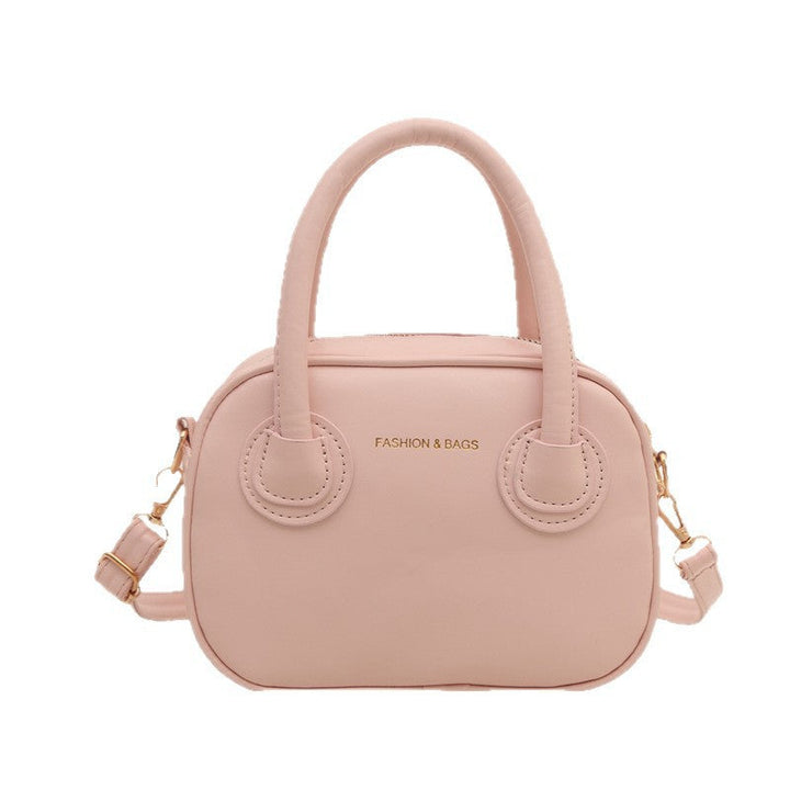 Ladies fashionable handbag with elegant pull handles and removable shoulder strap