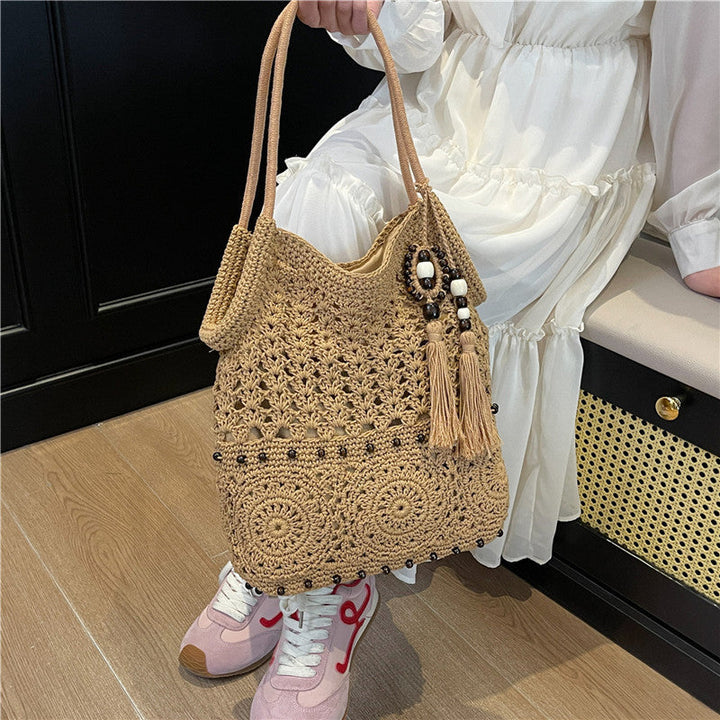 Ladies crocheted shoulder bag with decorative fringes and unique accents