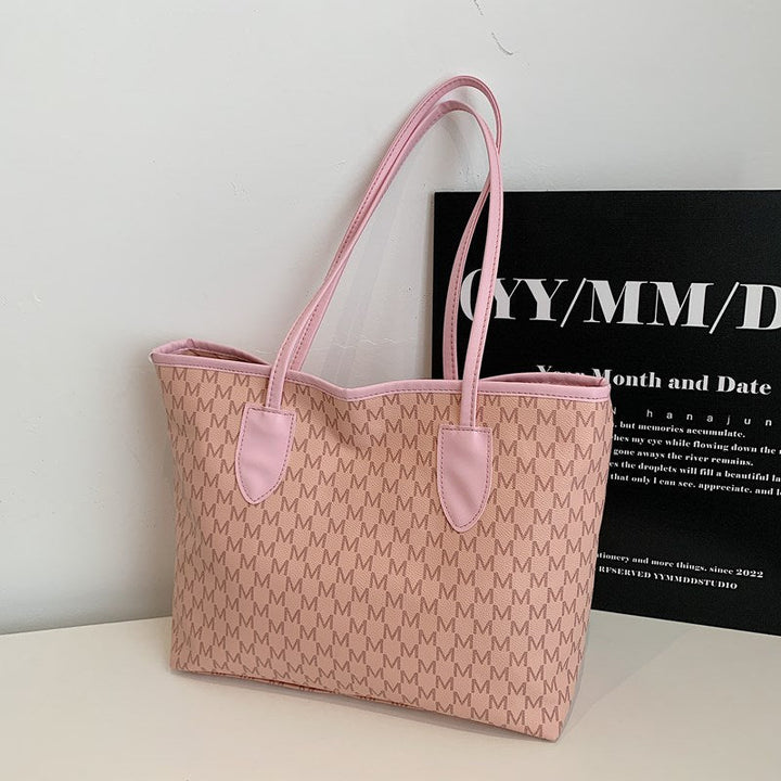 Women's tote bag made of high-quality, durable material with elegant monogram