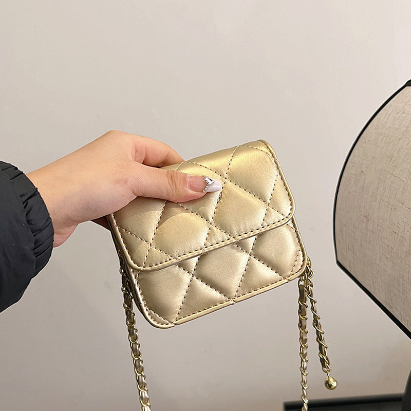 Ladies mini crossbody bag with shiny chain and charming pendant