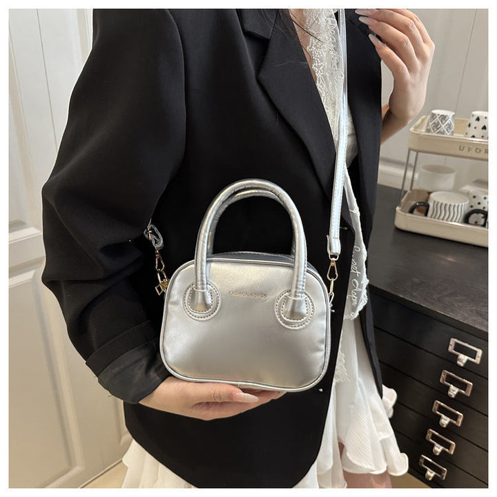 Ladies fashionable handbag with elegant pull handles and removable shoulder strap