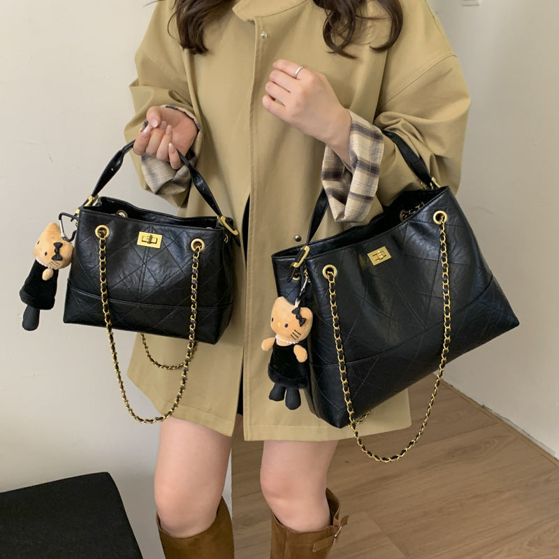 Women's shoulder bag with elegant chain accent and cute pendant