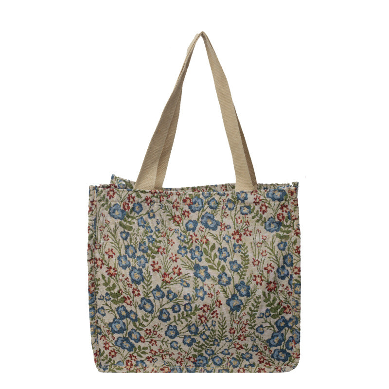 Women's tote bag with floral embroidery design and sturdy handles