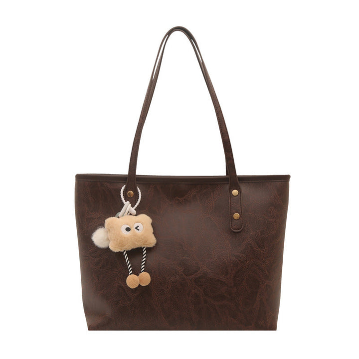 Women's classic tote bag with charming plush toy pendant