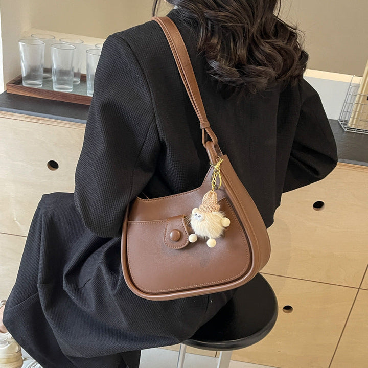Women's shoulder bag made of high-quality synthetic leather with playful charm