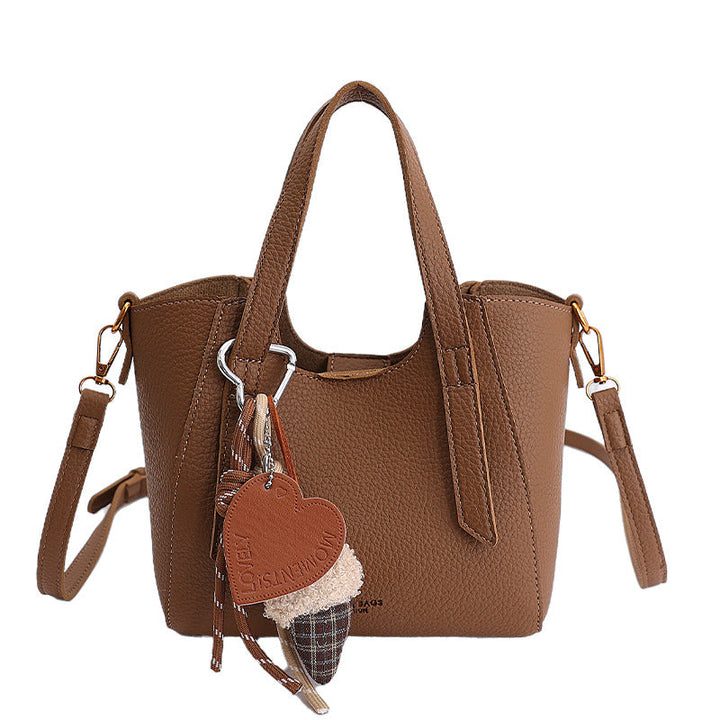 Women's mini handbag in an elegant design with charming pendant