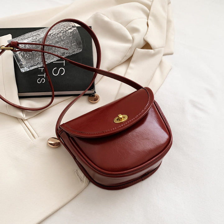 Women's shoulder bag in elegant retro design with golden accents