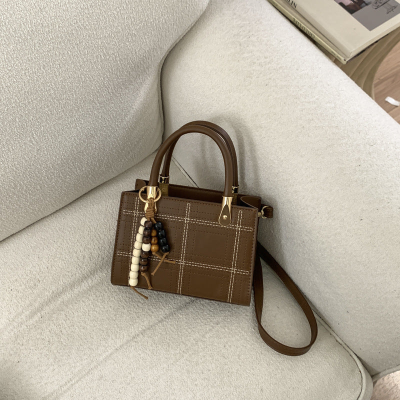 Women's mini handbag with elegant structure and golden accents