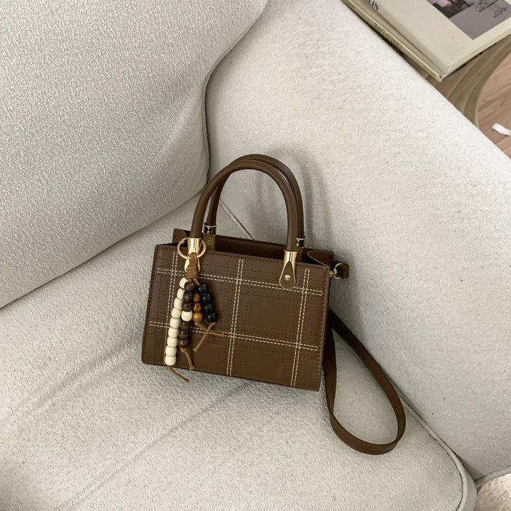 Women's mini handbag with elegant structure and golden accents
