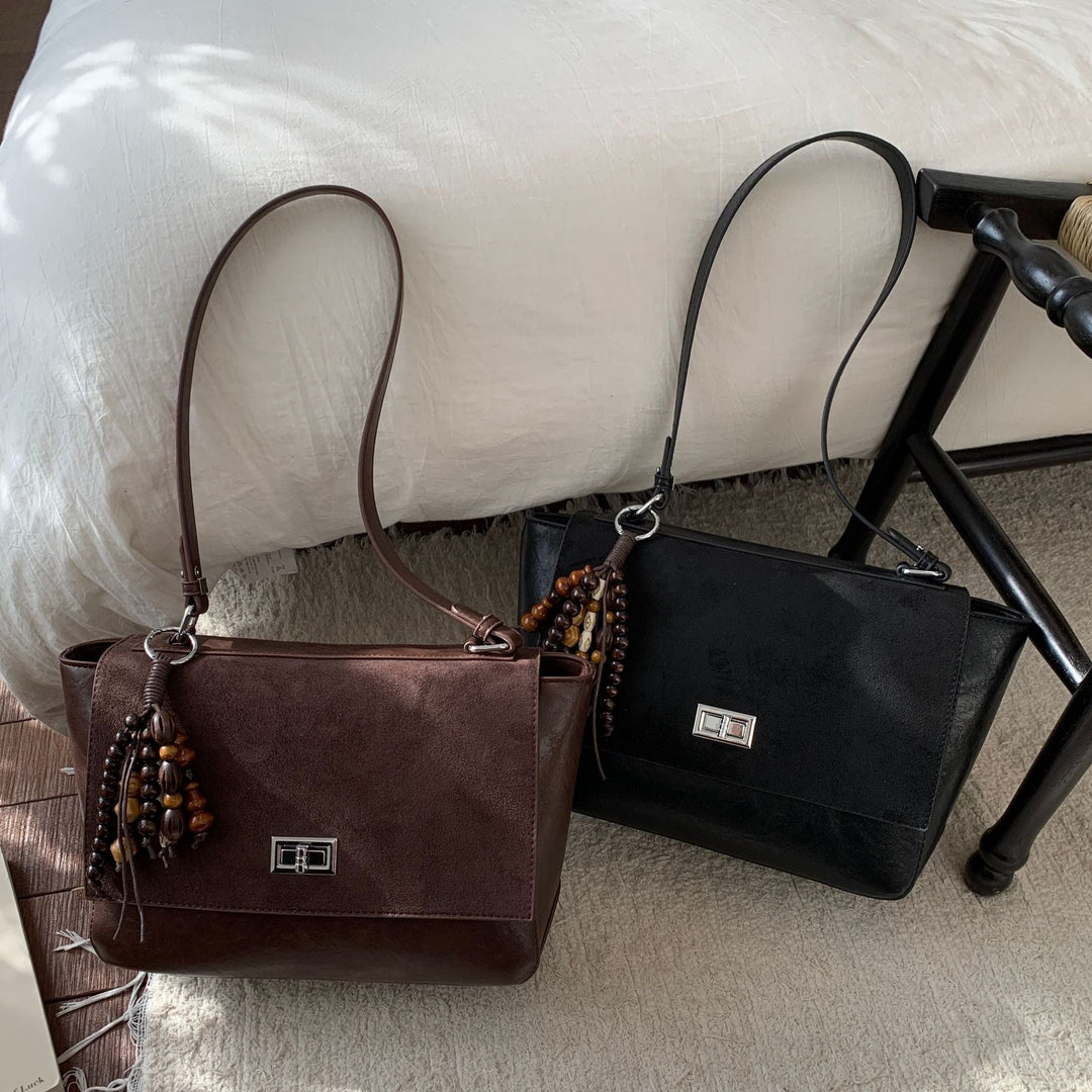 Women's elegant shoulder bag made of high-quality faux leather with playful charm