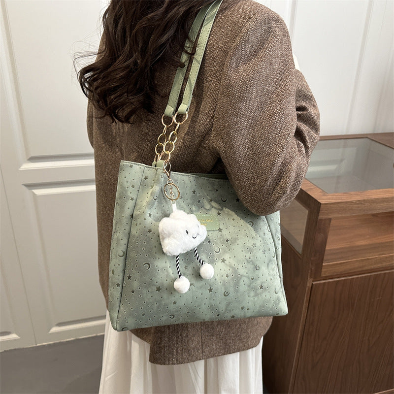 Women’s stylish tote bag with playful pendant