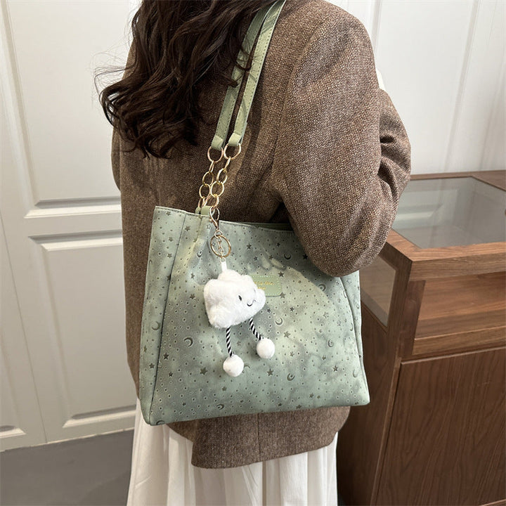 Women’s stylish tote bag with playful pendant