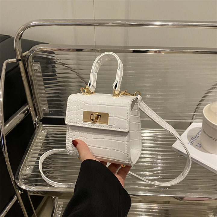 Ladies mini bag with elegant crocodile look and golden accents