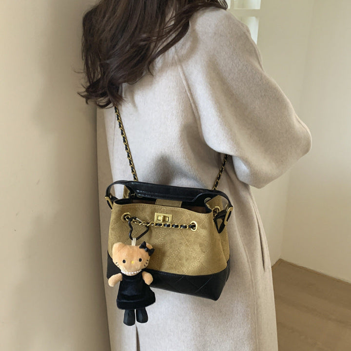 Women's shoulder bag with elegant chain accent and cute pendant