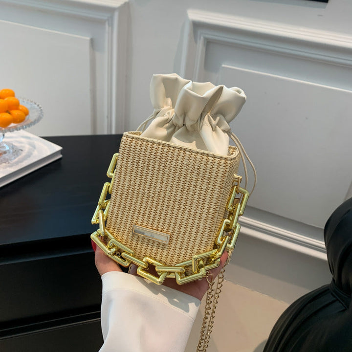 Women's mini handbag with unique chain embellishment and classic drawstring