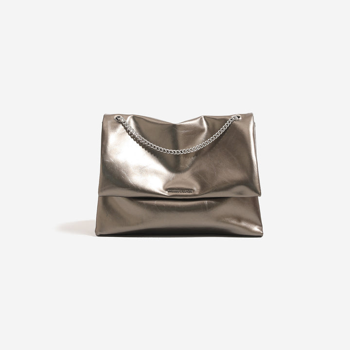 Women's clutch bag made of shiny synthetic leather with decorative chain strap