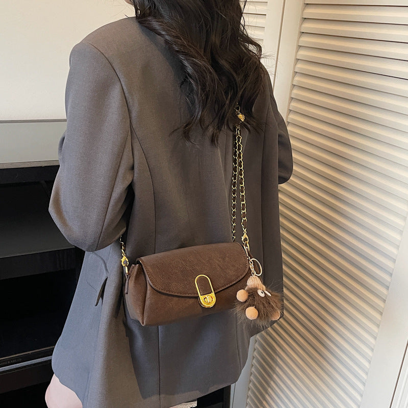 Women's shoulder bag with decorative pendant and luxurious chain strap