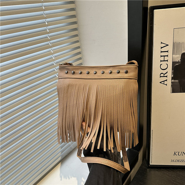 Ladies shoulder bag with fringes and studs