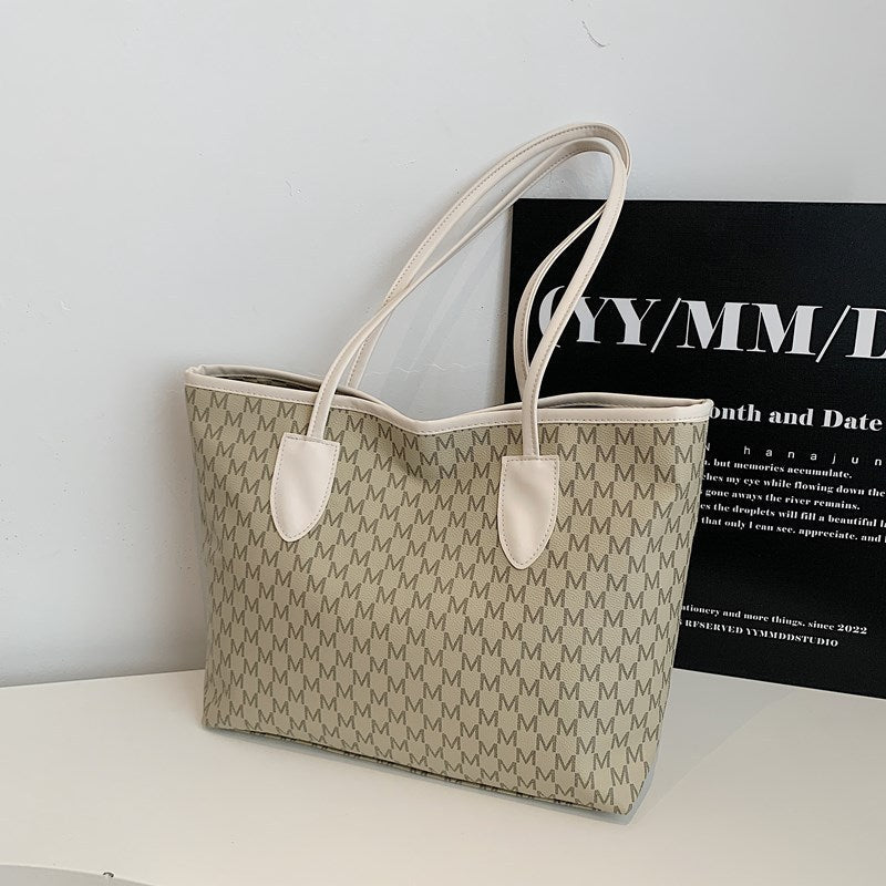 Women's tote bag made of high-quality, durable material with elegant monogram