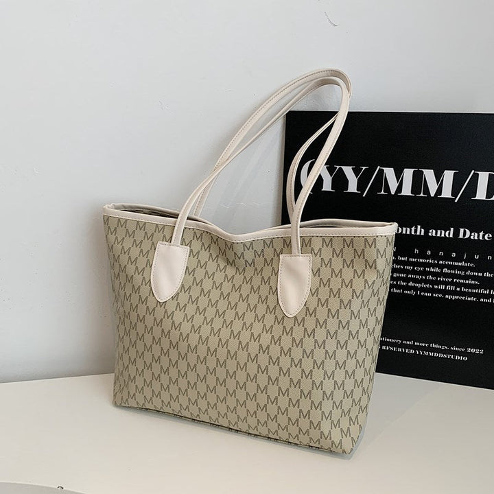 Women's tote bag made of high-quality, durable material with elegant monogram