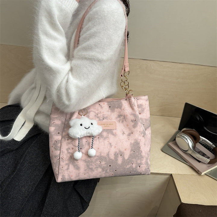 Women’s stylish tote bag with playful pendant