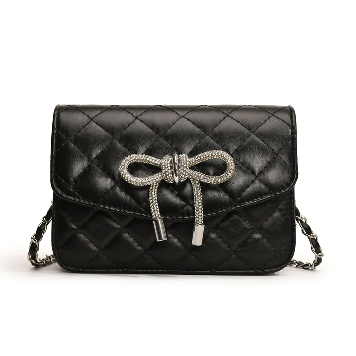 Ladies mini handbag with luxurious quilted pattern and sparkling chain pendant