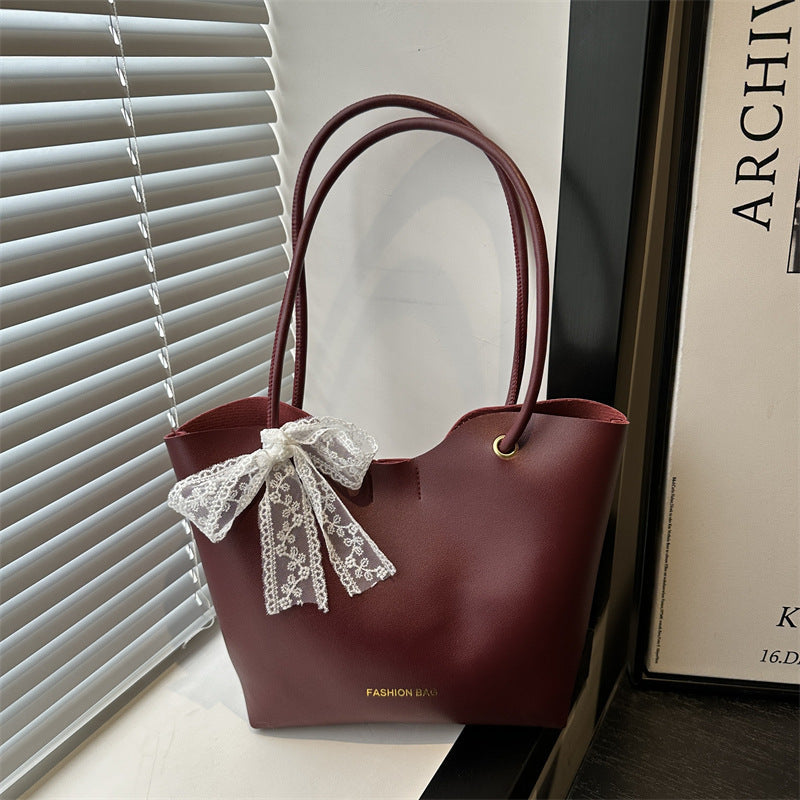 Women’s tote bag made of high-quality synthetic leather with playful bow detail