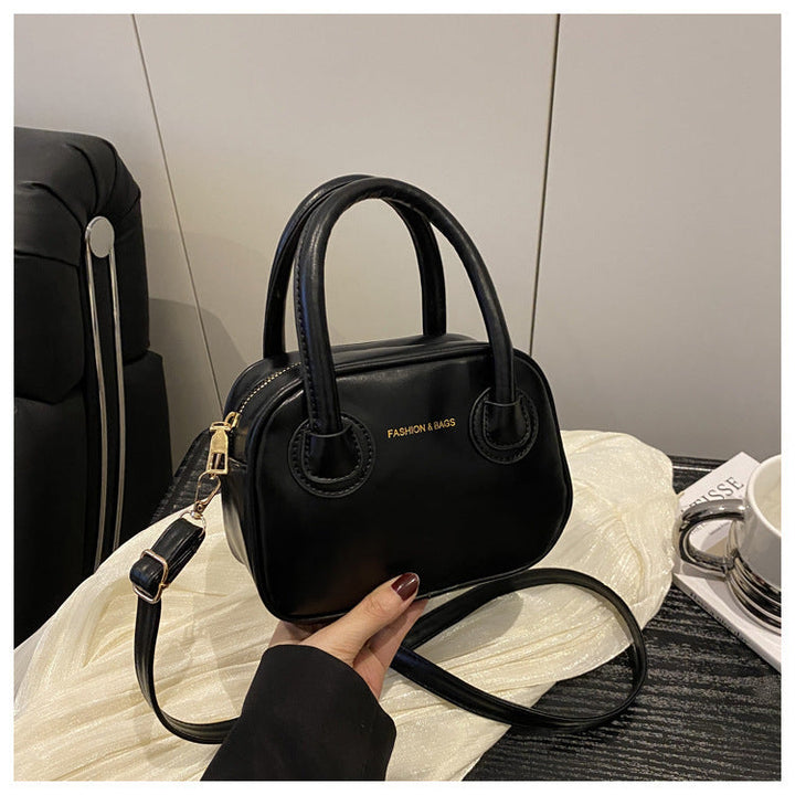 Ladies fashionable handbag with elegant pull handles and removable shoulder strap