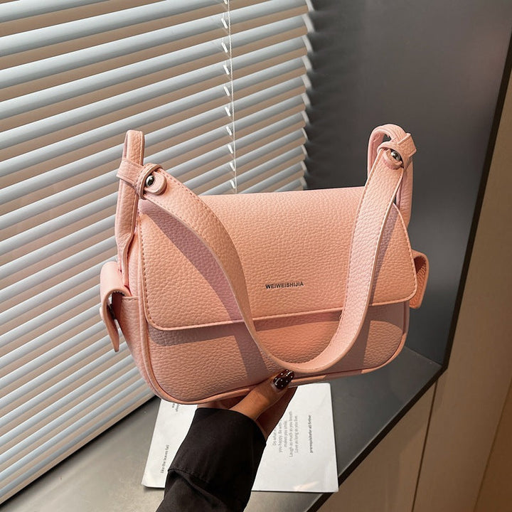 Women’s shoulder bag made of soft, textured leather with adjustable shoulder strap