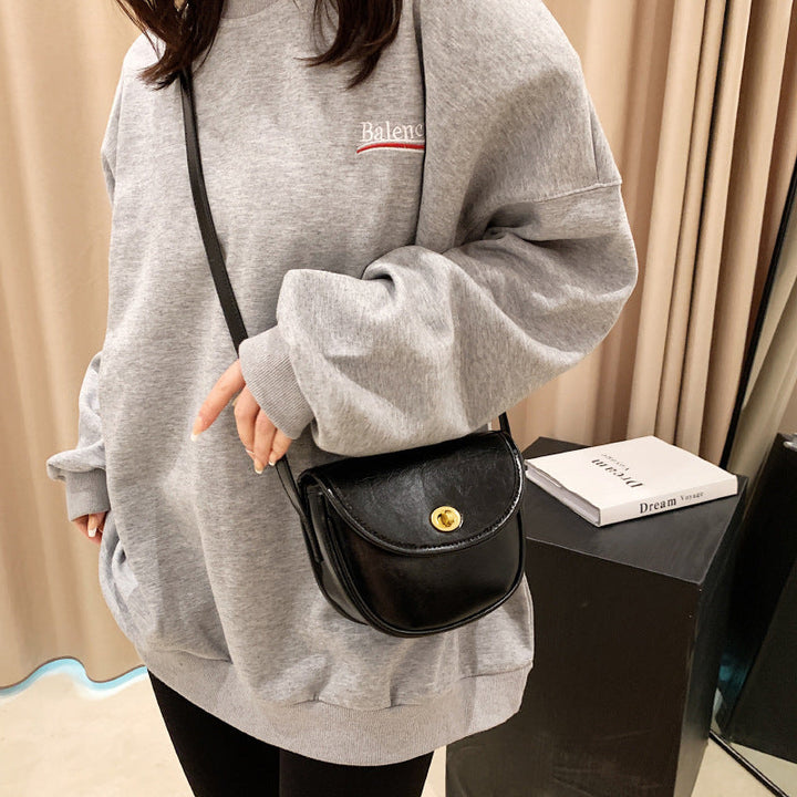 Women's shoulder bag in elegant retro design with golden accents