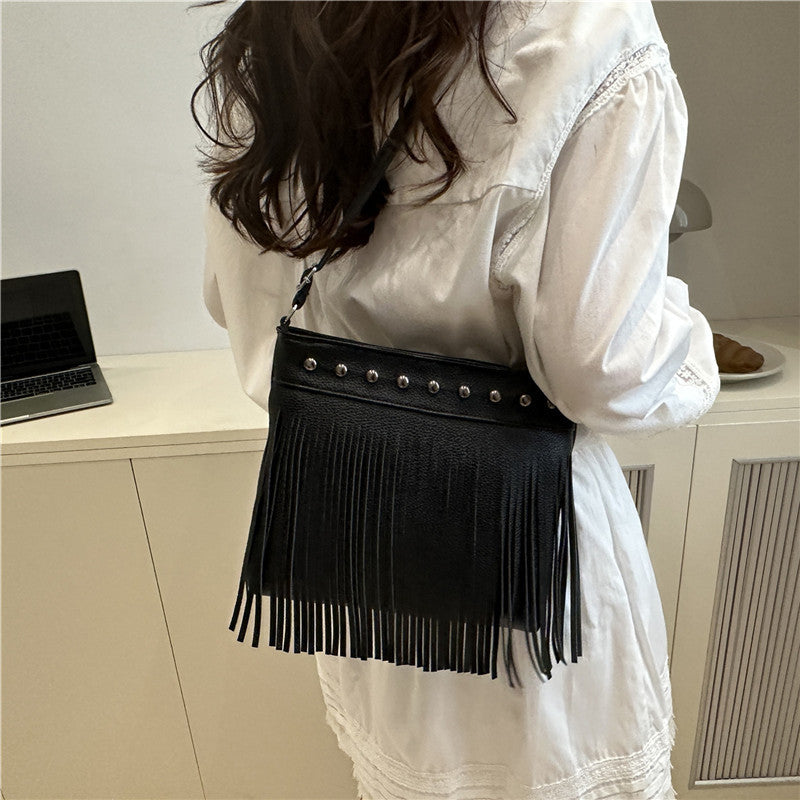 Ladies shoulder bag with fringes and studs