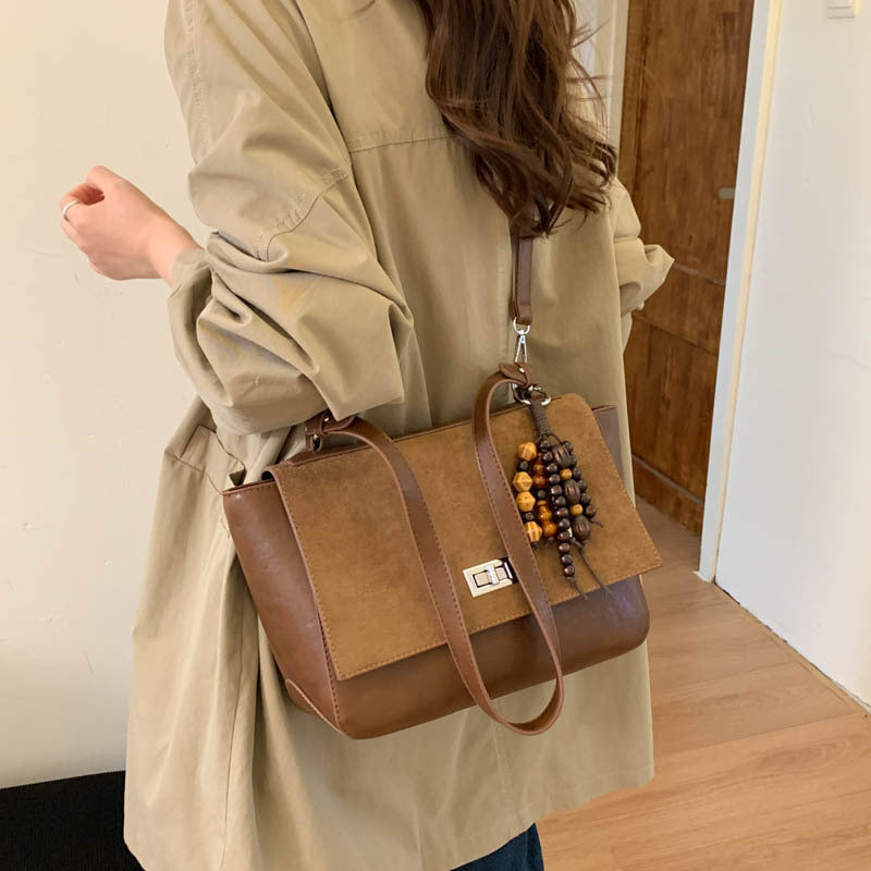 Women's elegant shoulder bag made of high-quality faux leather with playful charm