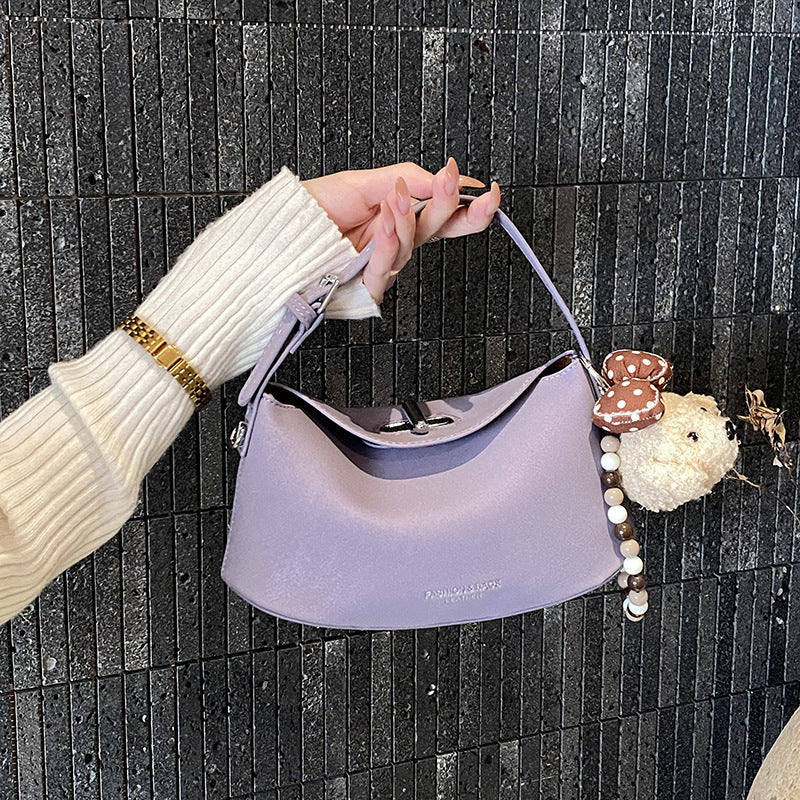 Women's shoulder bag with decorative pendant