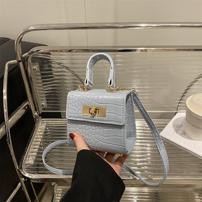 Ladies mini bag with elegant crocodile look and golden accents