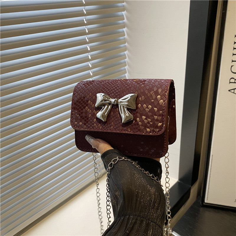 Women's clutch with playful bow design