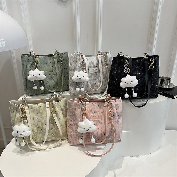 Women’s stylish tote bag with playful pendant