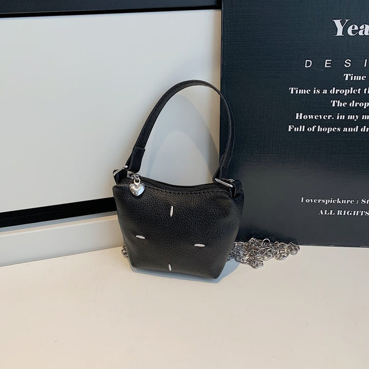 Women's mini handbag with shiny chain and textured upper material