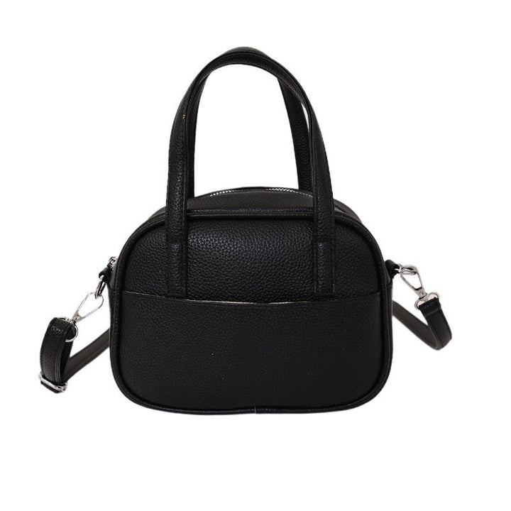 Women's mini handbag with playful animal charm