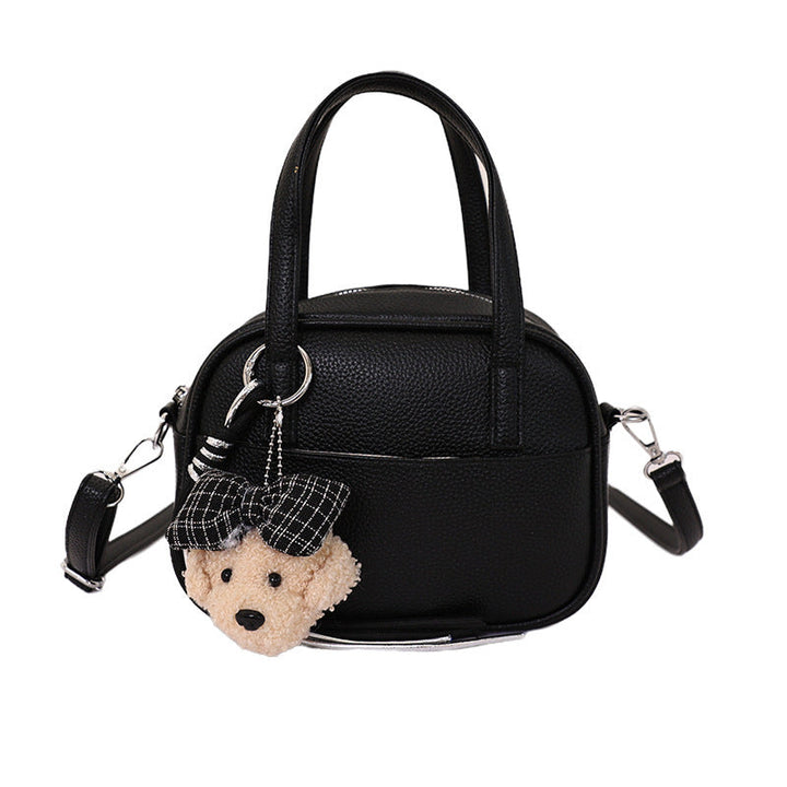 Women's mini handbag with playful animal charm