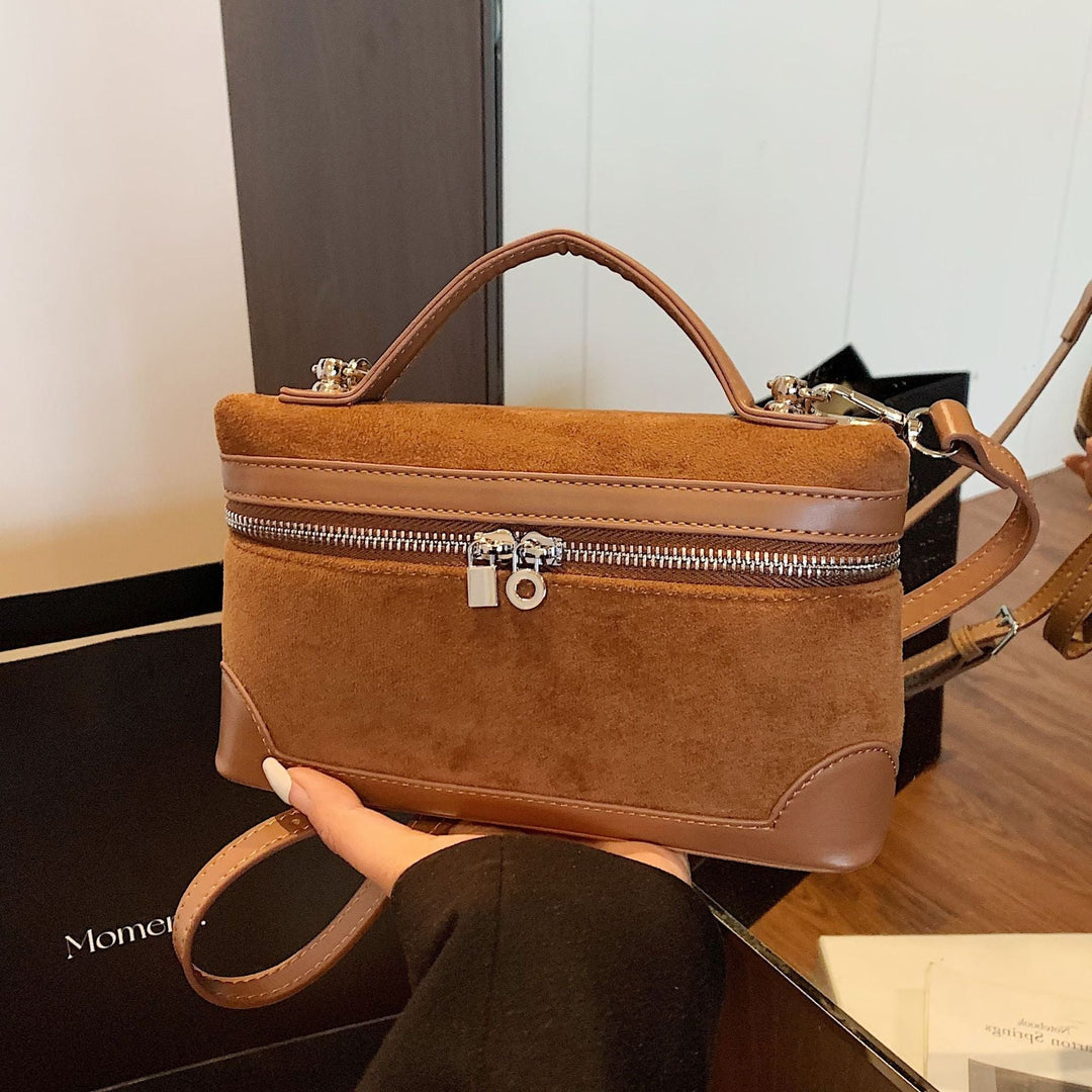 Women's shoulder bag made of soft suede leather with practical compartments