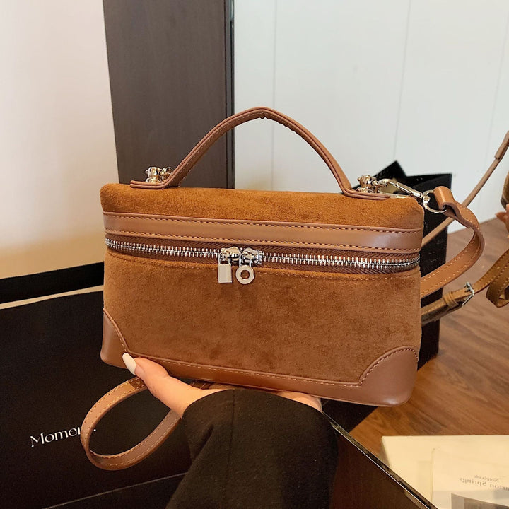 Women's shoulder bag made of soft suede leather with practical compartments
