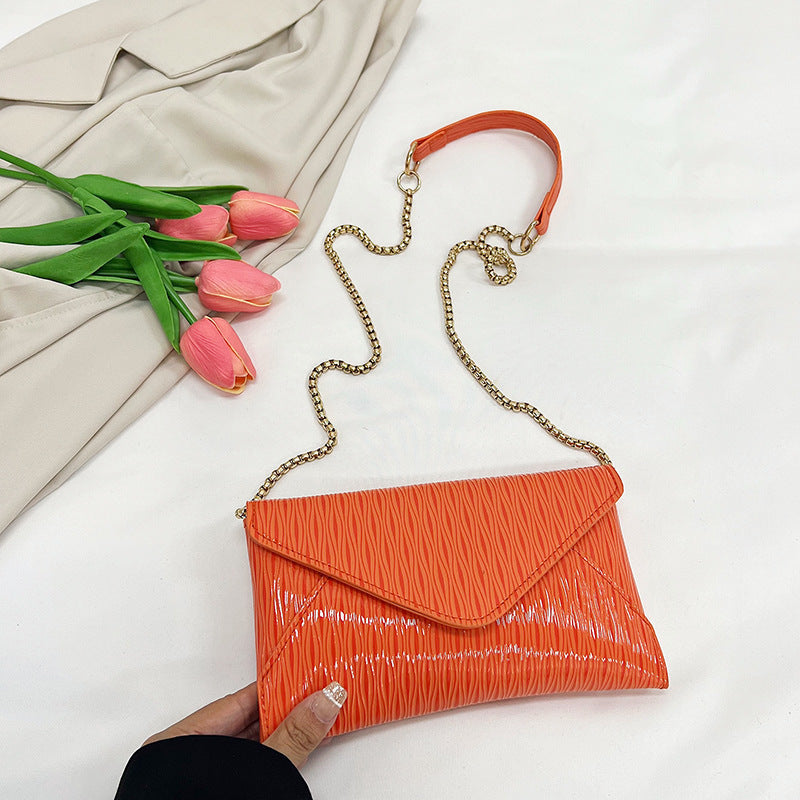 Women's elegant clutch with shiny upper material