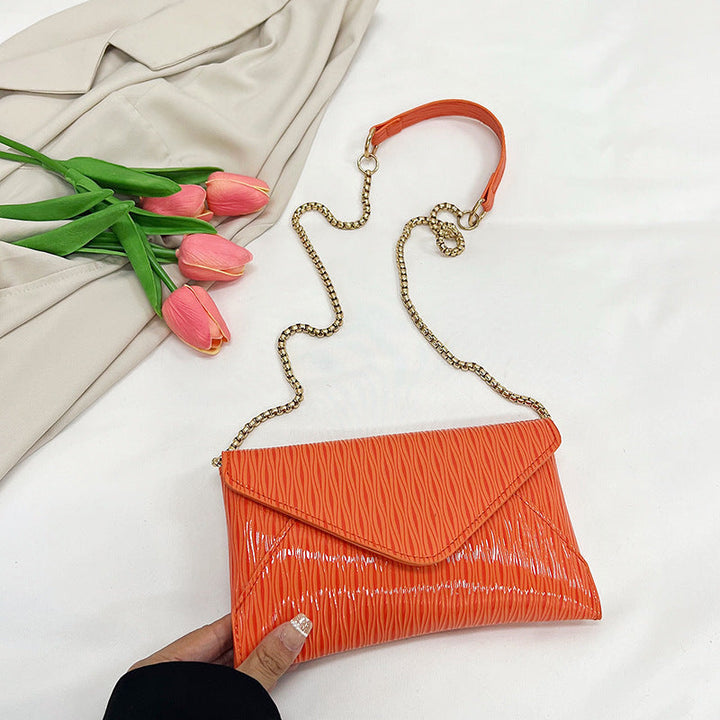 Women's elegant clutch with shiny upper material