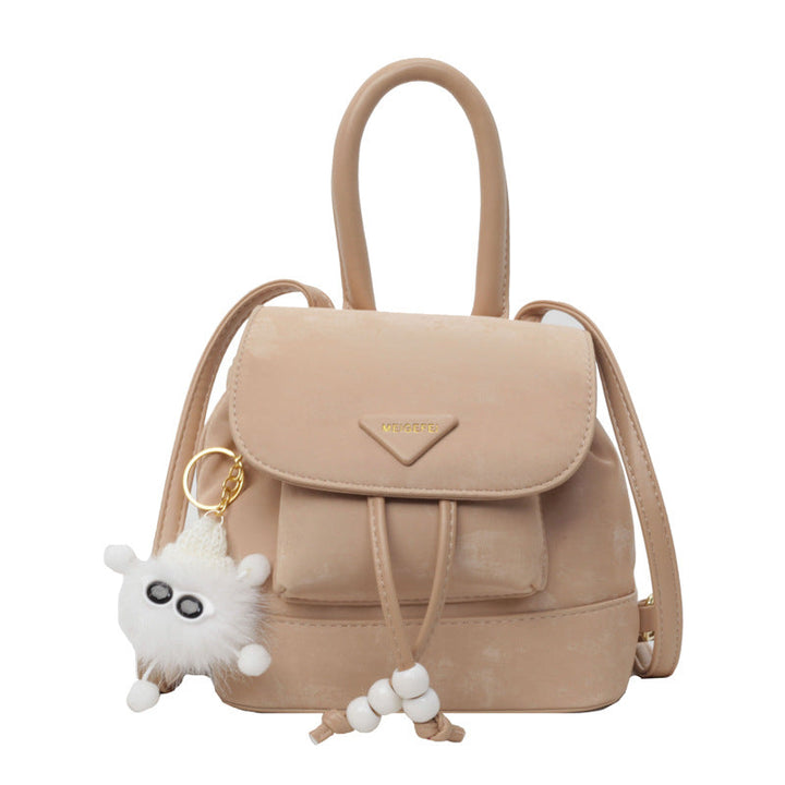 Women's mini backpack with playful design and plush pendant