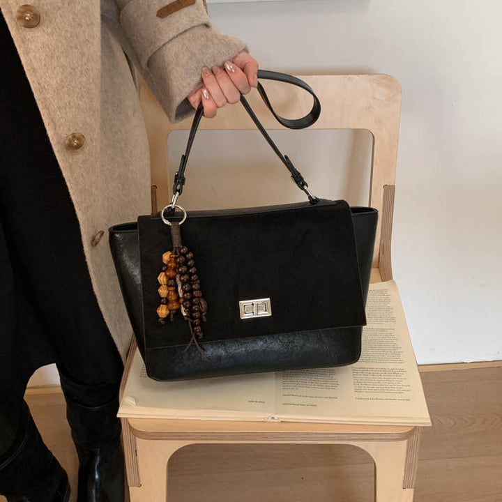 Women's elegant shoulder bag made of high-quality faux leather with playful charm