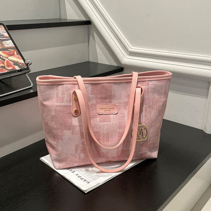 Women's stylish tote bag with textured design and elegant details