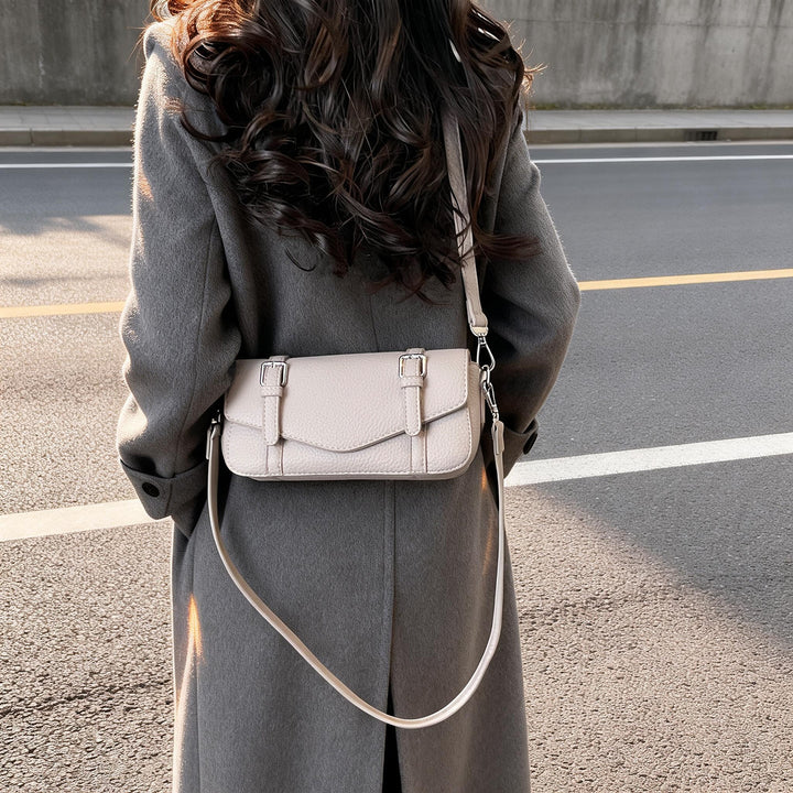 Women's elegant shoulder bag made of textured synthetic leather with adjustable shoulder strap