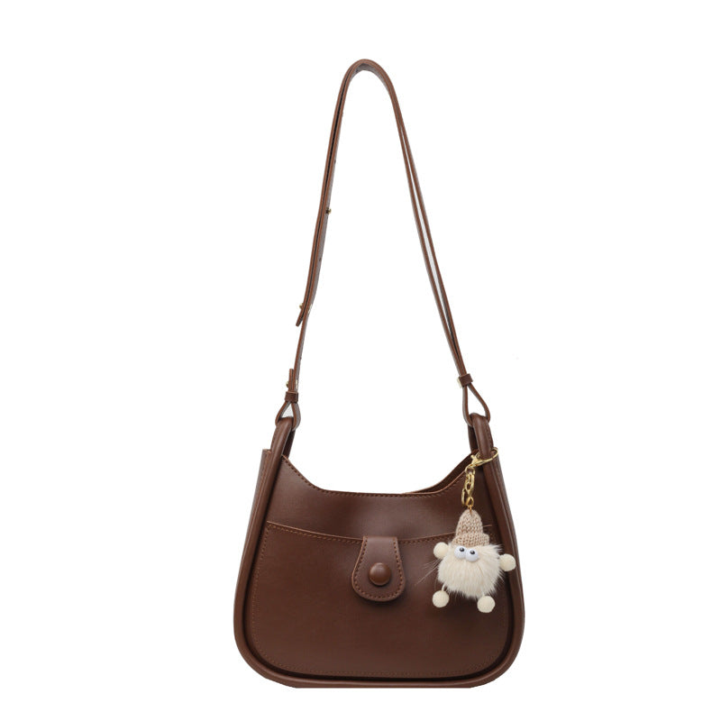 Women's shoulder bag made of high-quality synthetic leather with playful charm
